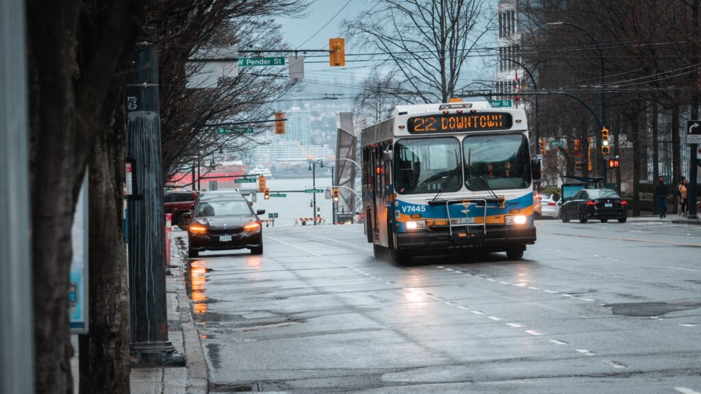 a bus driving down a street next to a traffic light